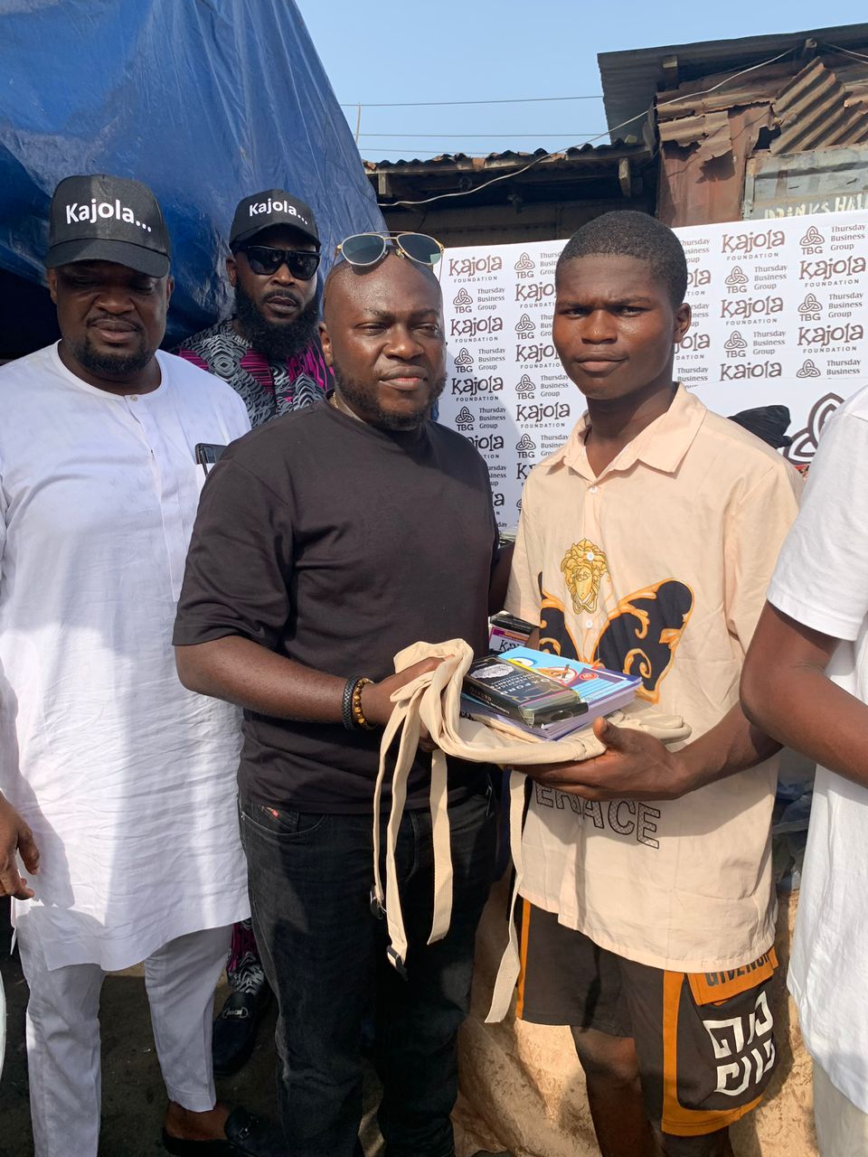 TBG members presenting materials to a young man