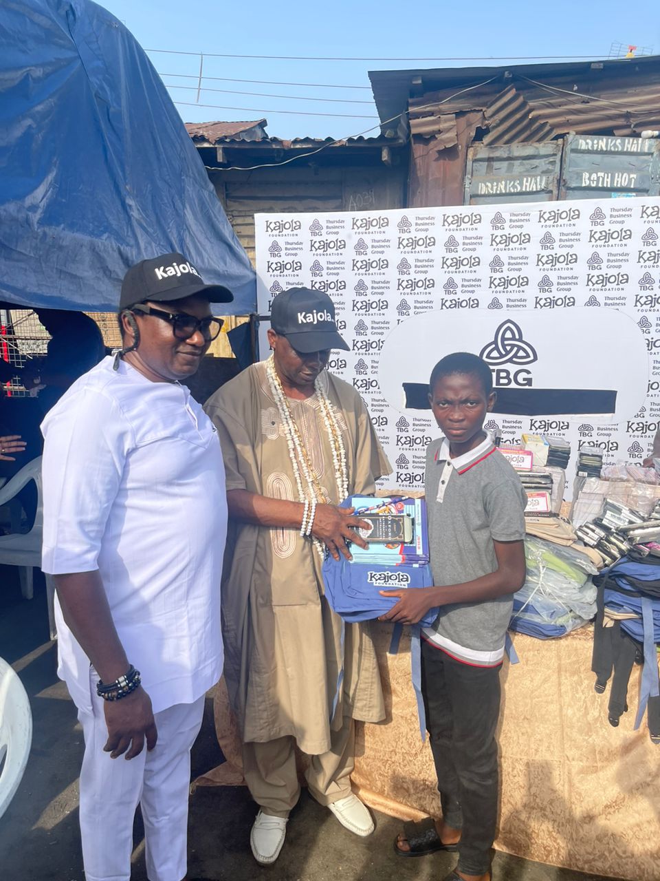 Kajola Foundation presenting school supplies to a student