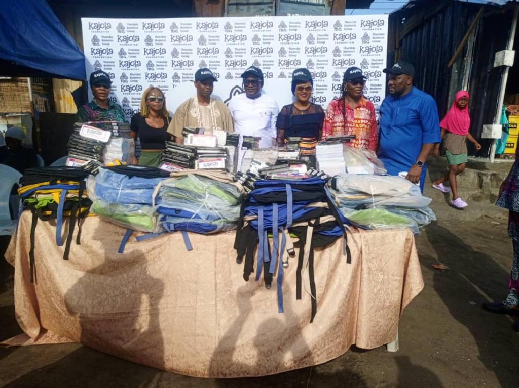 Kajola Foundation team behind a table of school supplies